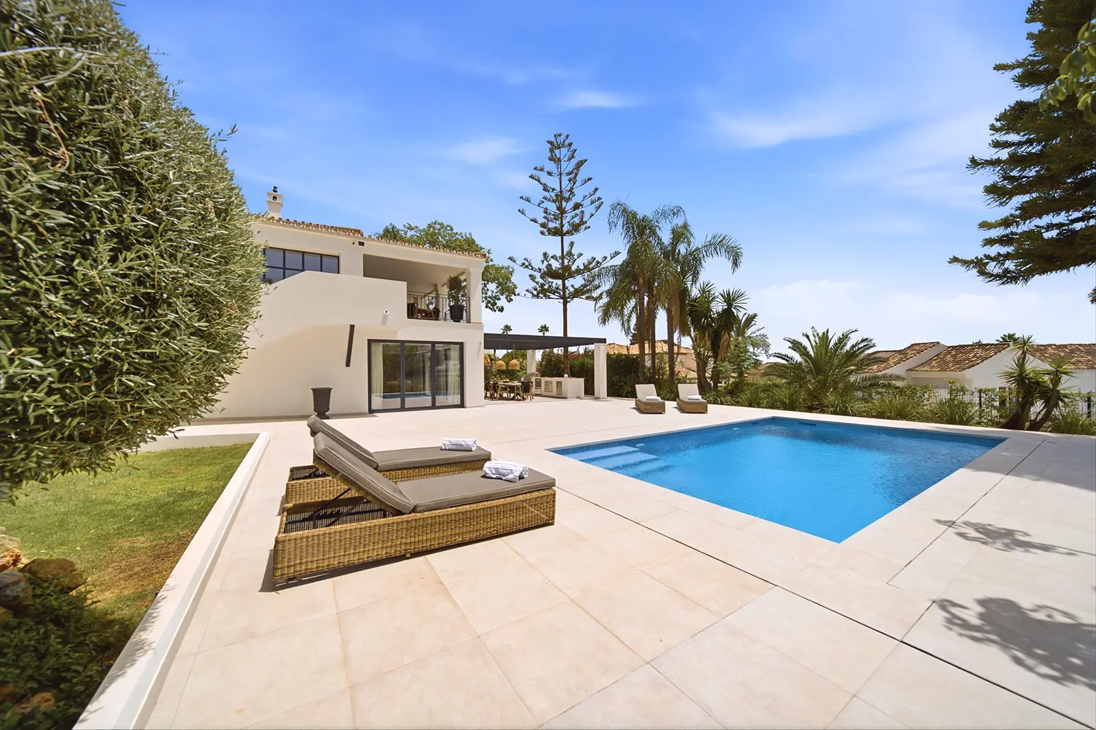 Pool terrace at Felisa with sun loungers and the villa behind